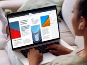 A woman viewing a PDF file on her Mac laptop.